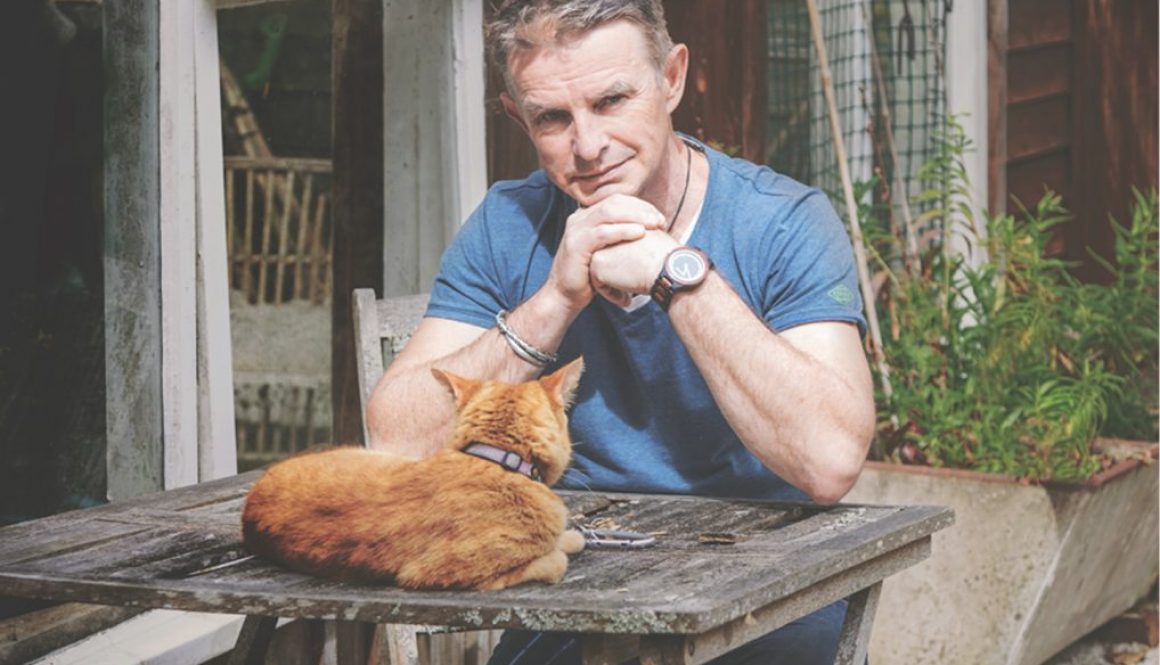 Mal White with his cat in the garden