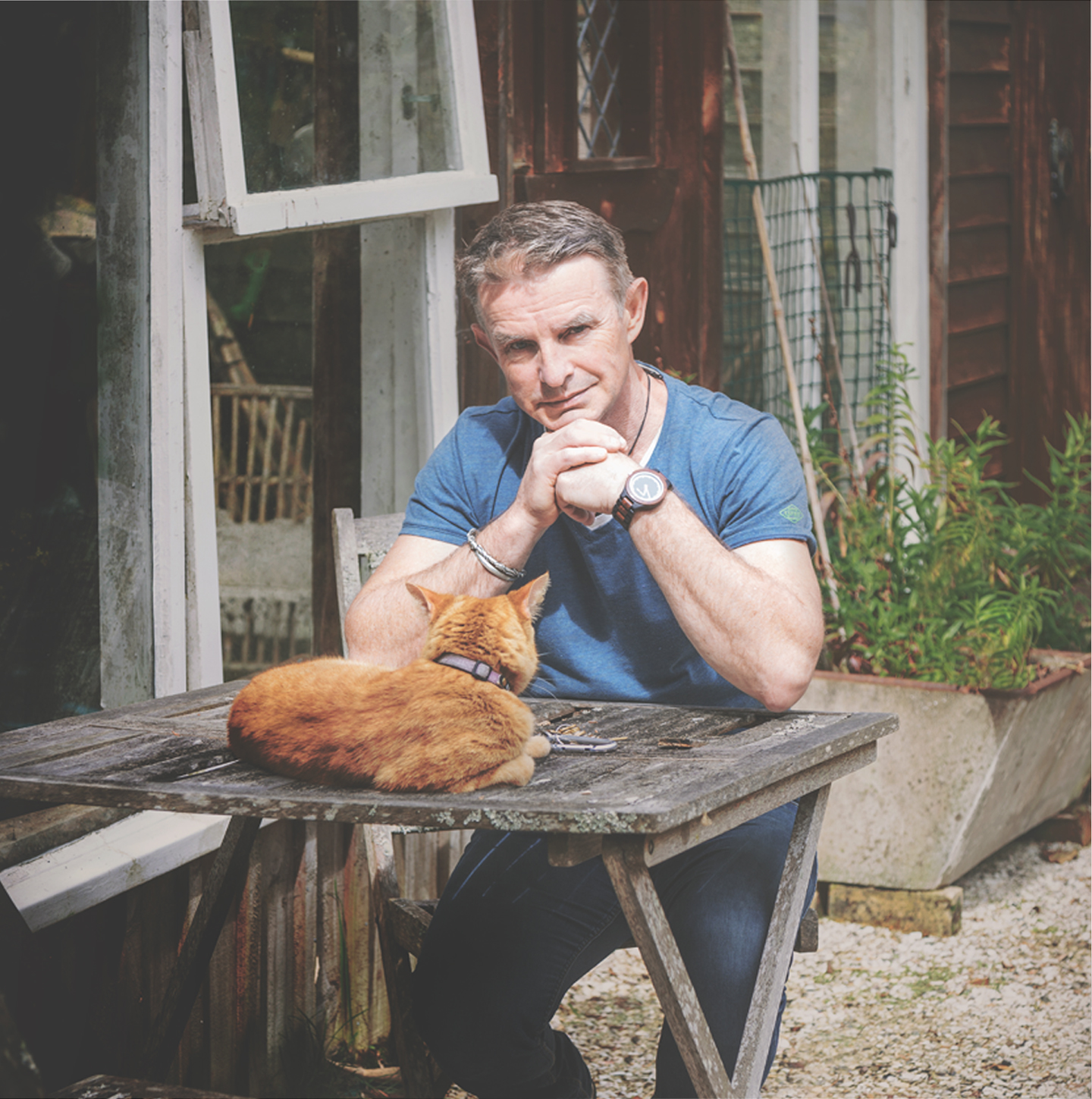 Mal White with his cat in the garden